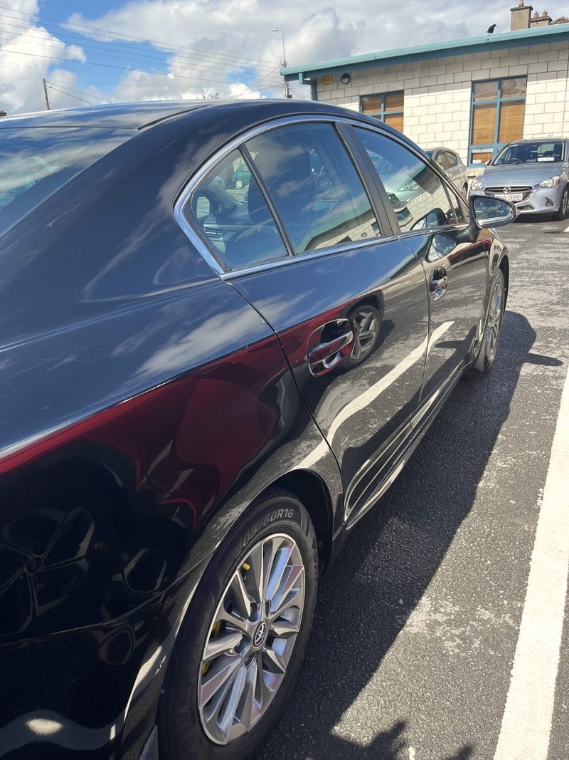 Black Toyota Avensis with a deep shine on the paint