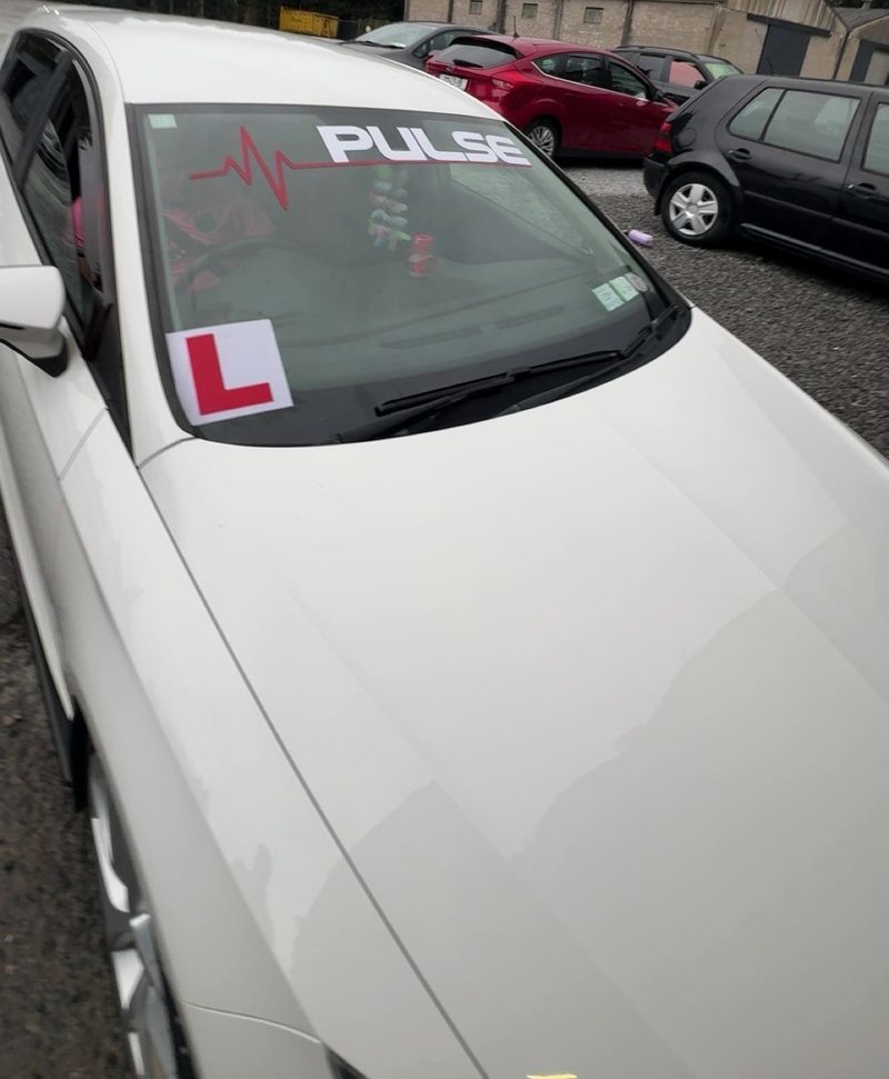 White hatchback, custom sun strip